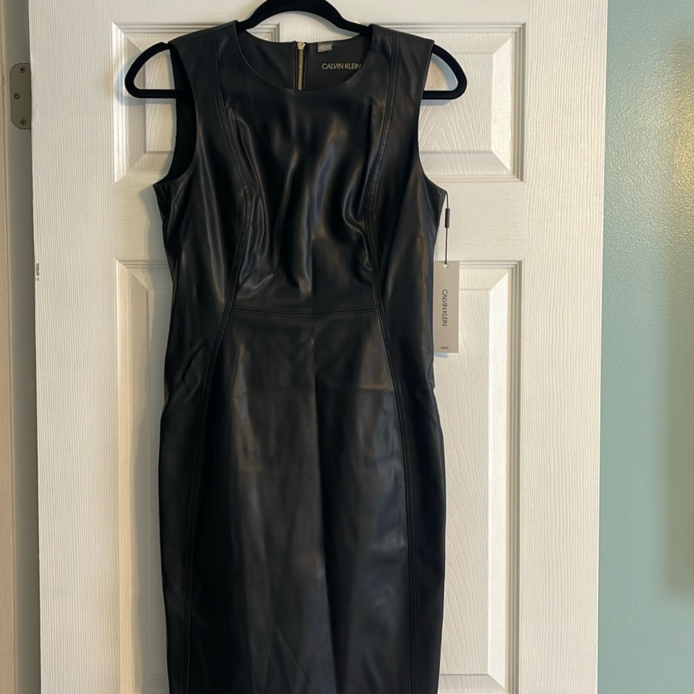 Brand new Calvin Klein black faux leather sheath with gold back zipper in back.